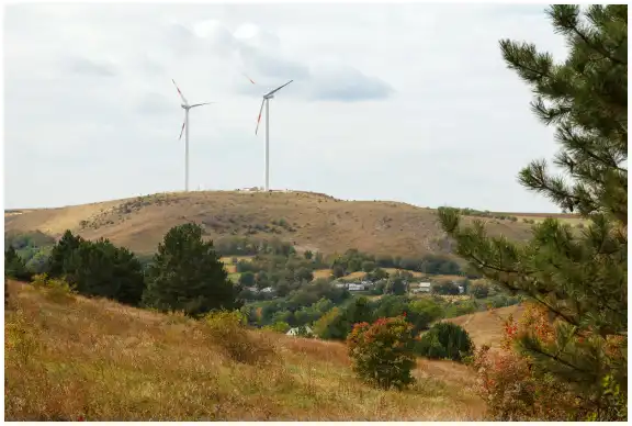 Two wind turbines on a hill in Moldova.